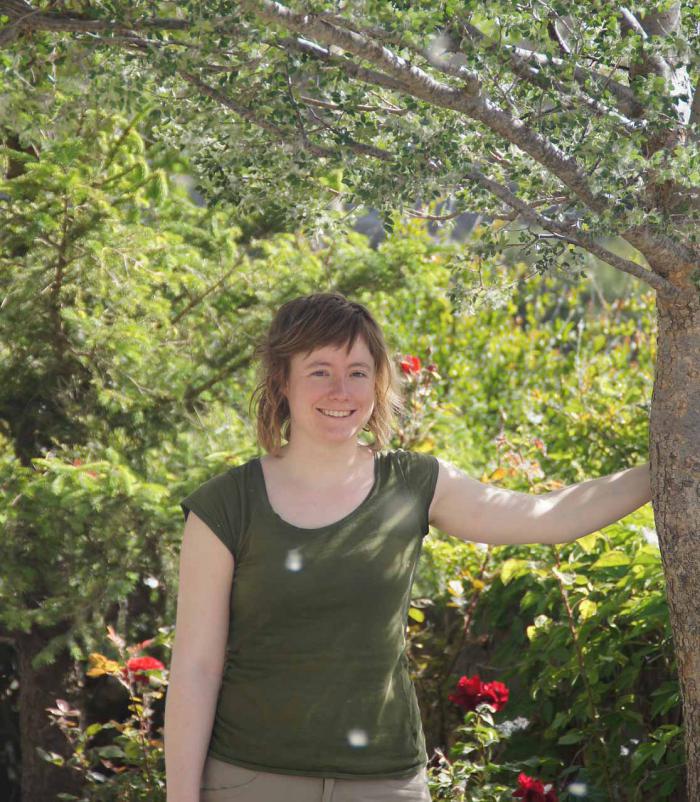 PhD student Laurence Fazan in front of a planted Zelkova abelicea tree in a private garden in western Crete.